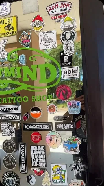 The Firstmind shop front on Beach Boulevard, sticker-covered glass door