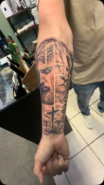 Blackwork lettering sleeve on a forearm