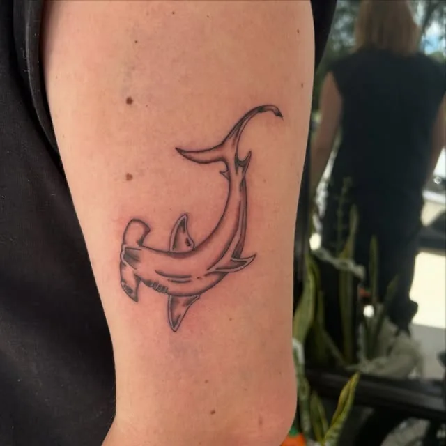 Single continuous line dolphin on an upper arm