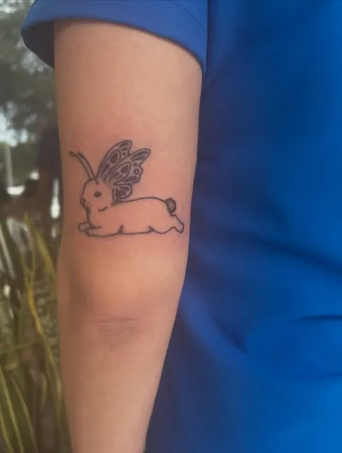Fine line winged hare on the back of an arm